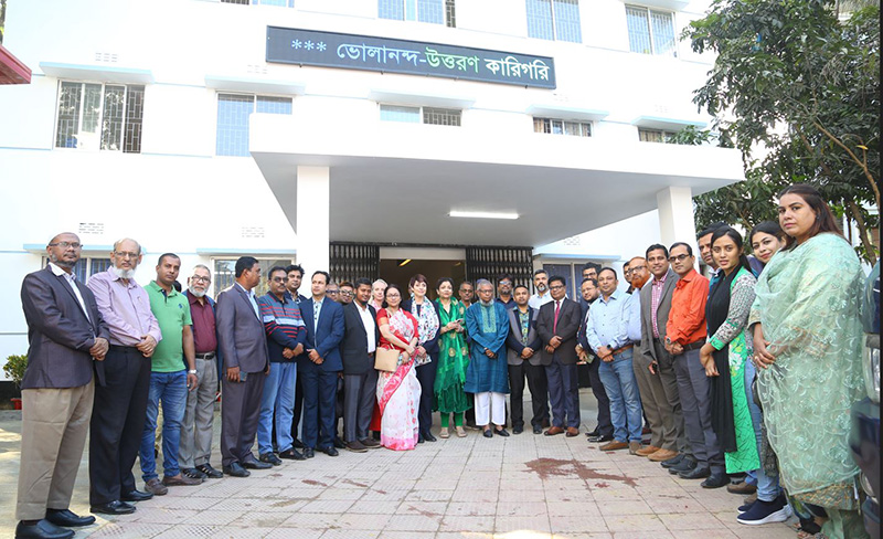 a group of people standing in front of the building