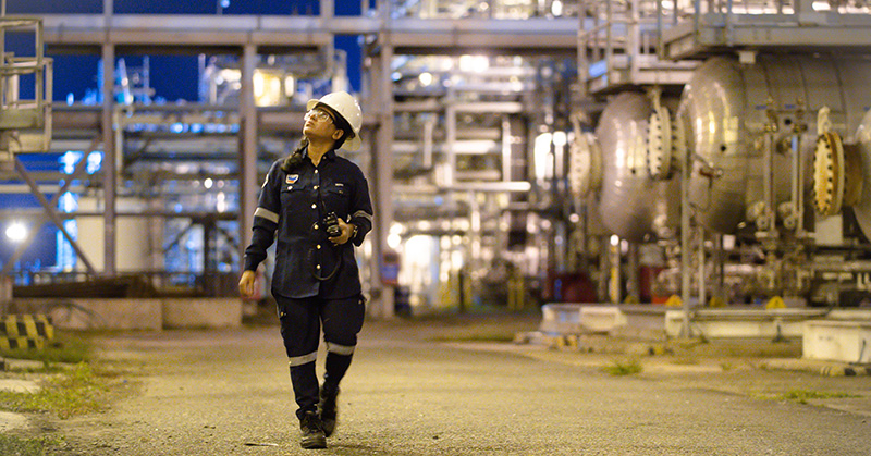 a worker waking through a facility